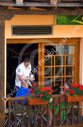 People dine on the balcony of a restaurant in the town of Potes, Liebana, Cantabria, northwestern Spain.