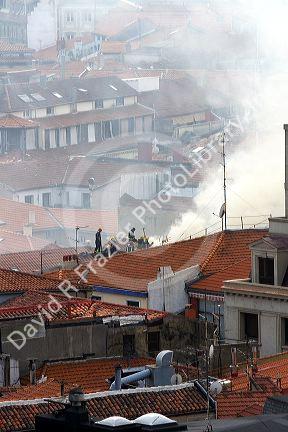 Firefighters on the roof of an apartment on fire in the city of Bilbao, Biscay, northern Spain.
