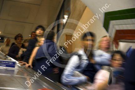 People ride an escalator in the London Underground metro system in London, England.
