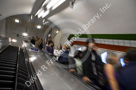 People ride an escalator in the London Underground metro system in London, England.