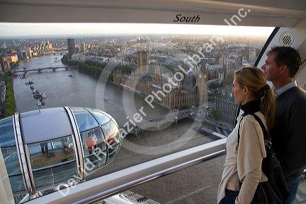 Tourists view the city of London from the London Eye, England.