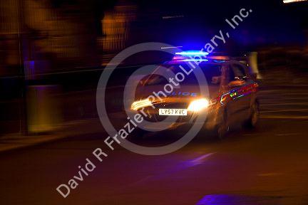 Police car in motion at night in London, England.