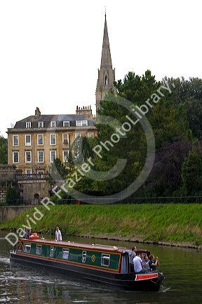 Narrowboat traveling on the River Avon in the city of Bath, Somerset, England.