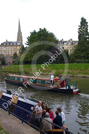 People ride on narrowboats on the River Avon in the city of Bath, Somerset, England.