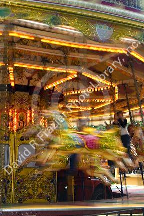 Merry-go-round in motion in the market town of Stratford-upon-Avon, Warwickshire, England.