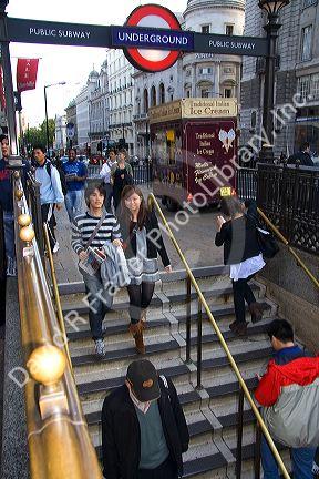 People entering and exiting the London Underground metro system in the city of London, England.