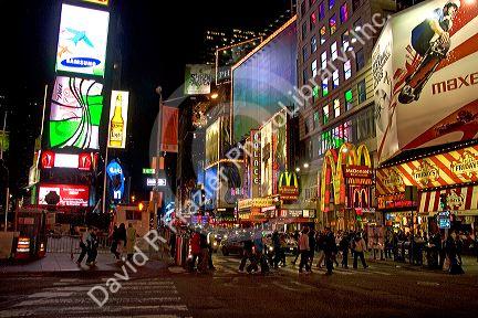 Pedestrians in Times Square at night in Manhattan, New York City, New York, USA.