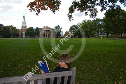 Student reading a book on the campus of Dartmouth College located in the town of Hanover, New Hampshire, USA.
