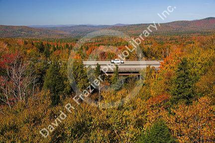 Car driving on Interstate 89 through Franconia Notch State Park with fall foliage, New Hampshire, USA.