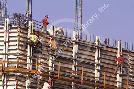 Construction workers work with rebar on a new highrise building.