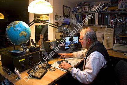 Ham radio operator in his radio shack located in Shelton, Washington, USA. MR