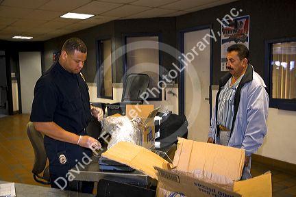 Immigrant having his possesions searched to enter the United States port of entry at the Tijuana, Baja California, Mexico/San Diego, California border crossing.