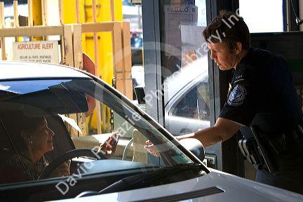 U.S. Customs and Immigration agent greets a person entering the United States port of entry at the Tijuana, Baja California, Mexico/San Diego, California border crossing.
