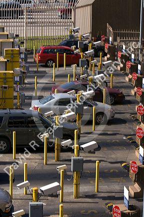 Automobiles being monitored by video cameras wait to enter the United States port of entry at the Tijuana, Baja California, Mexico/San Diego, California border crossing.
