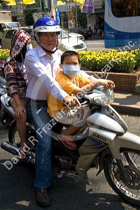 Vietnamese family ride a motorbike in Ho Chi Minh City, Vietnam.