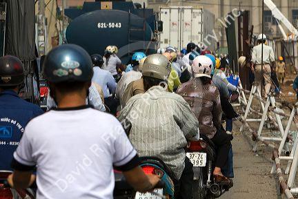 Vietnamese people ride motorbikes in Ho Chi Minh City, Vietnam.