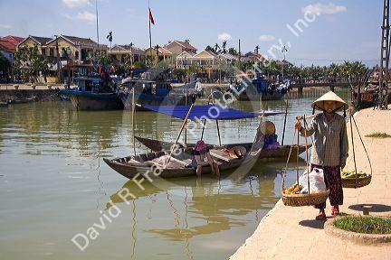 Vietnamese women selling produce along the Thu Bon River at Hoi An, Vietnam.
