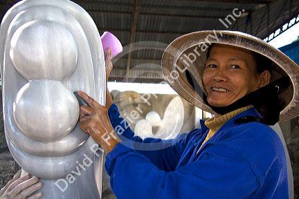 Vietnamese woman carving marble sculptures at a shop in Ngu Hanh Son ward south of Da Nang, Vietnam.