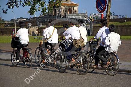 Vietnamese students ride bicycles in Hue, Vietnam.