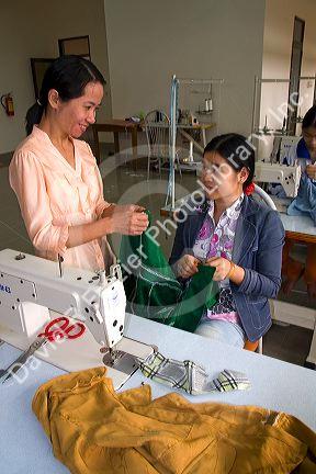 Disadvantaged Vietnamese youth learn to use a sewing machine at a vocational school named Kids First Vietnam in Dong Ha, Vietnam.