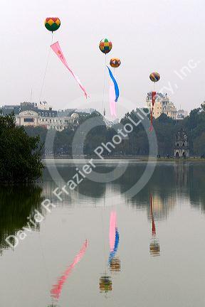 Tet decoration of large balloons float above Hoan Kiem Lake in Hanoi, Vietnam.