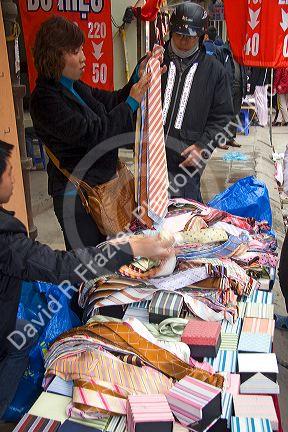 Silk necktie vendor on the street in Hanoi, Vietnam.
