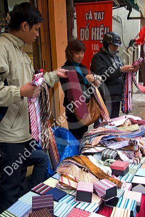 Silk necktie vendor on the street in Hanoi, Vietnam.
