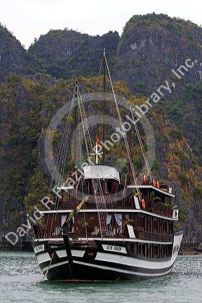 Scenic views of limestone isles and boats in Ha Long Bay, Vietnam.
