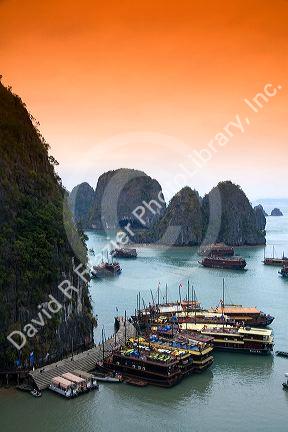 Scenic views of limestone karsts and tourist boats in Ha Long Bay, Vietnam.