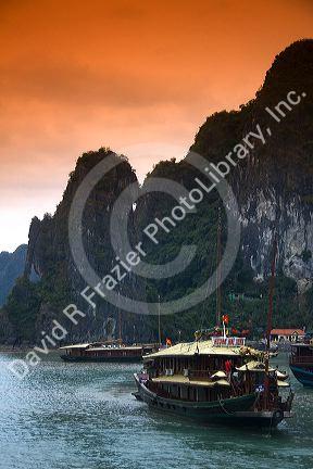 Scenic views of limestone karsts and tourist boats in Ha Long Bay, Vietnam.