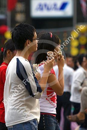 Vietnamese teens eat ice cream in Ho Chi Minh City, Vietnam.