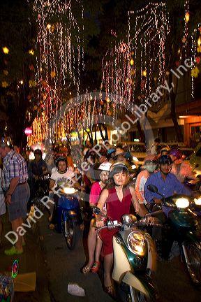 Vietnamese people ride motorbikes on Dong Khoi street during the last night of Tet Lunar New Year celebrations in Ho Chi Minh City, Vietnam.