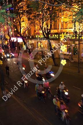 Vietnamese people ride motorbikes on Dong Khoi street during the last night of Tet Lunar New Year celebrations in Ho Chi Minh City, Vietnam.