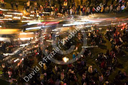 Motion of motorbikes moving through crowds of people celebrating Tet in Hanoi, Vietnam.