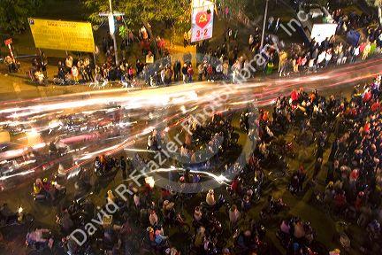 Motion of motorbikes moving through crowds of people celebrating Tet in Hanoi, Vietnam.