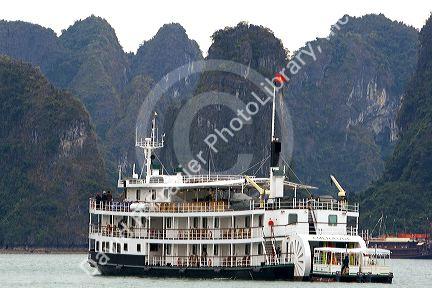 Scenic views of limestone isles and boats in Ha Long Bay, Vietnam.