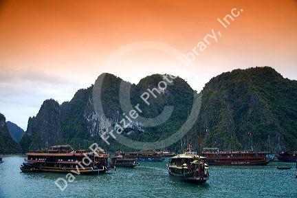 Scenic views of limestone karsts and tourist boats in Ha Long Bay, Vietnam.
