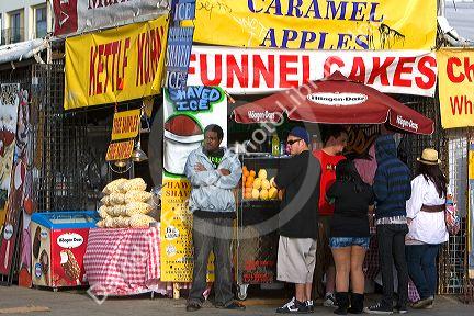 People and boardwalk retail space at Venice Beach, Los Angeles, California.