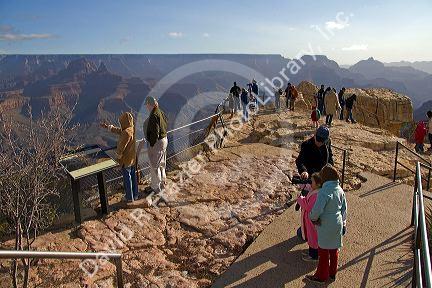 Tourists view the South Rim of the Grand Canyon, Arizona, USA.