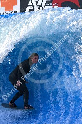 Woman surfing on a man made wave machine at Mission Beach, San Diego, Southern California, USA. MR