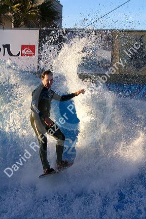 Man surfing on a man made wave machine at Mission Beach, San Diego, Southern California, USA.