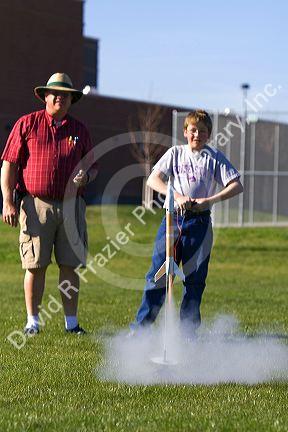Father and son launching a model rocket for science education in Boise, Idaho.