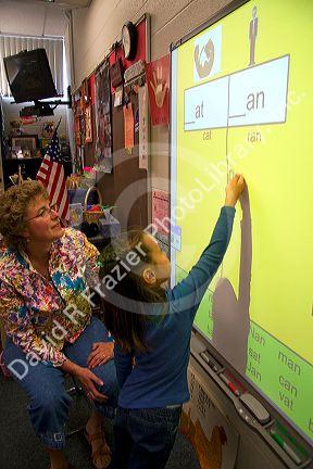 Kindergarten students use an interactive whiteboard in the classroom of a public school in Boise, Idaho, USA. MR