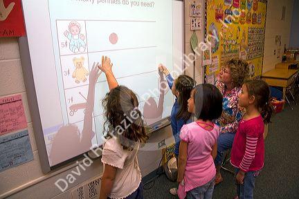 Kindergarten students use an interactive whiteboard in the classroom of a public school in Boise, Idaho, USA. MR