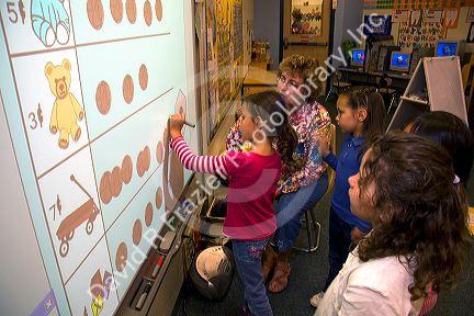 Kindergarten students use an interactive whiteboard in the classroom of a public school in Boise, Idaho, USA. MR
