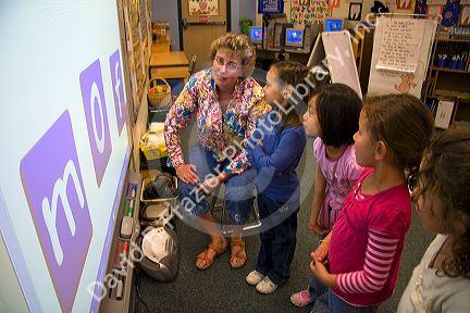 Kindergarten students use an interactive whiteboard in the classroom of a public school in Boise, Idaho, USA. MR