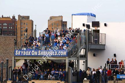 Fans watch a Cubs baseball game from a luxury skybox at Wrigley Field in Chicago, Illinois, USA.
