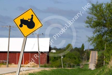 Tractor crossing road sign in Sauk County, Wisconsin, USA.