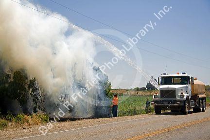 Water truck putting out a residential fire in Canyon County, Idaho, USA.