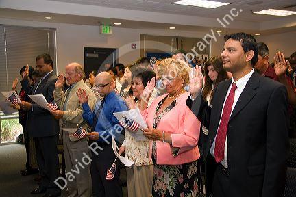 New United States citizens raise their right hand for citizenship oath ceremony in Idaho, USA.